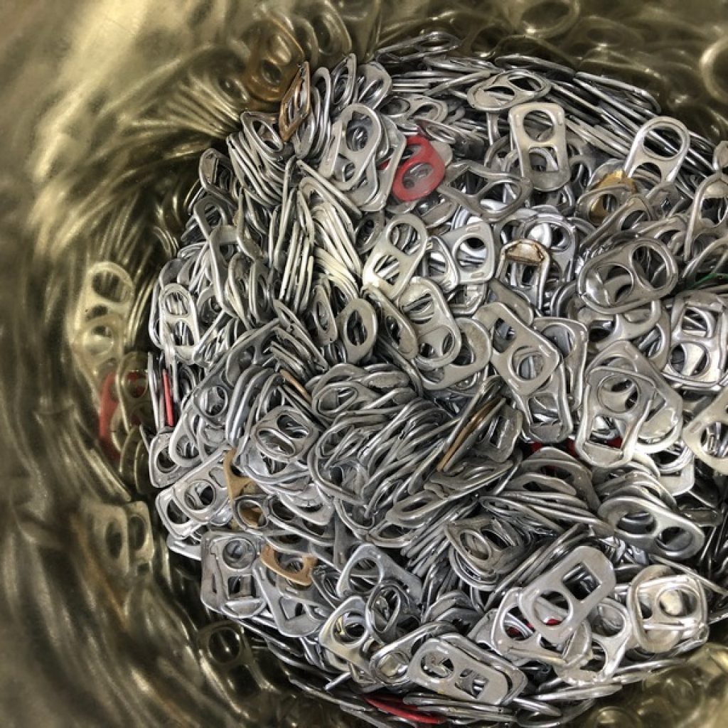 pile of soda tabs collected for years to repurpose at home